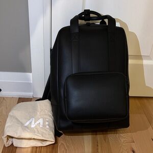 Brand new Monos Metro Backpack in black vegan leather with dustbag- Unisex